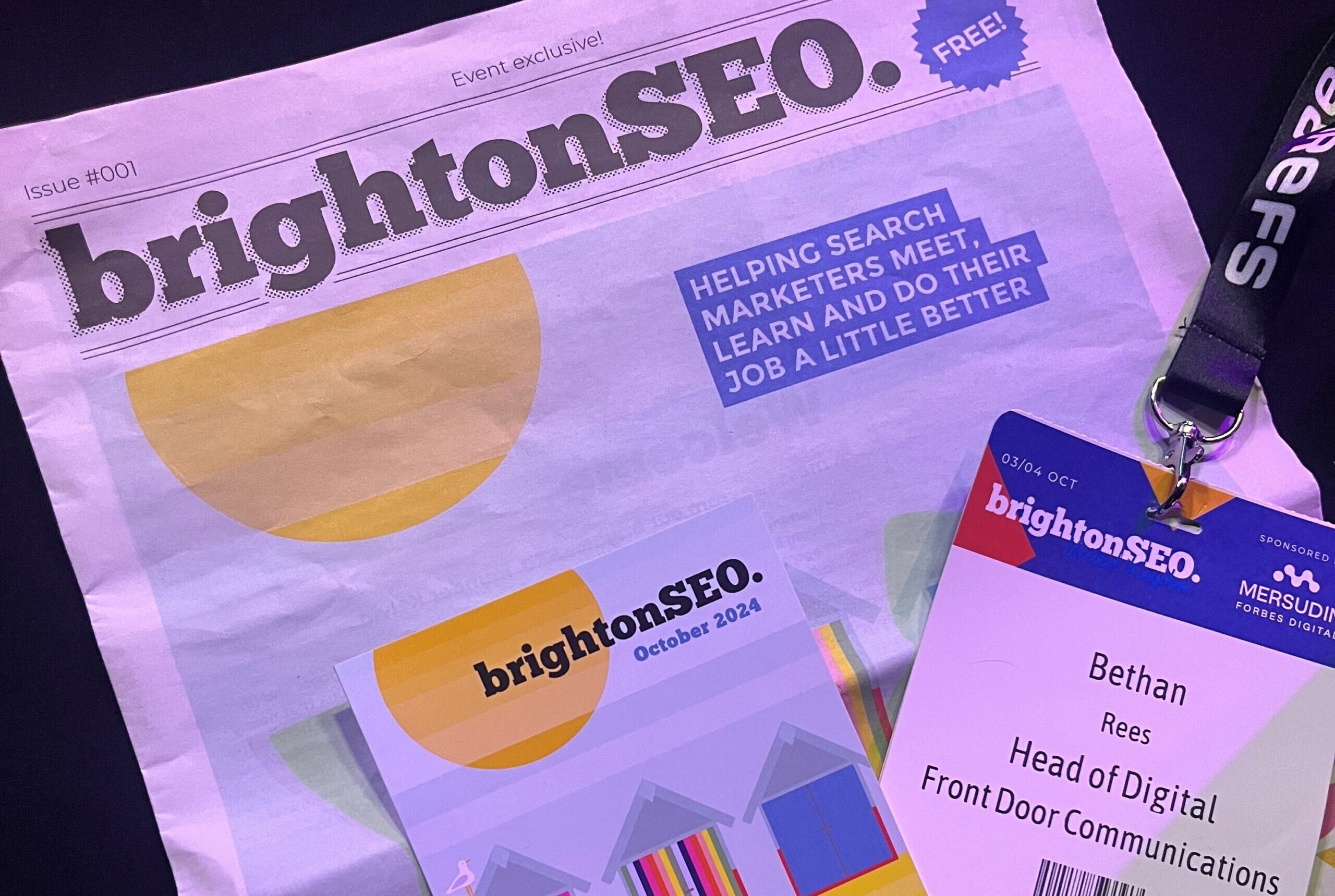 newspaper and lanyard from BrightonSEO 2024