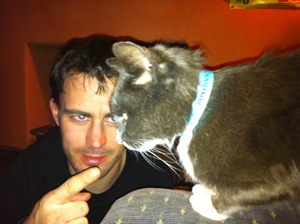 Comedian and inventor Robin Wealleans alongside Lentil, his black and white cat.