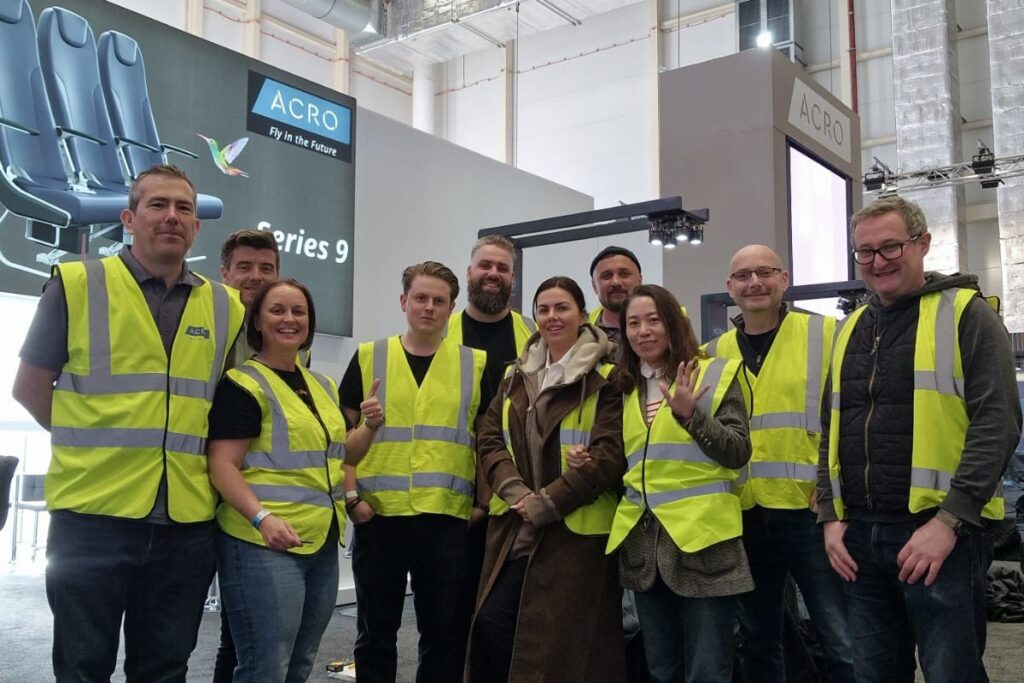 A group of people standing together in yellow vests
