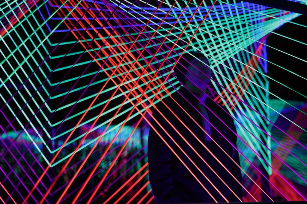 A man standing in the middle of a light exhibition