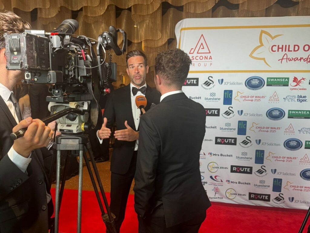 Someone being filmed on a red carpet