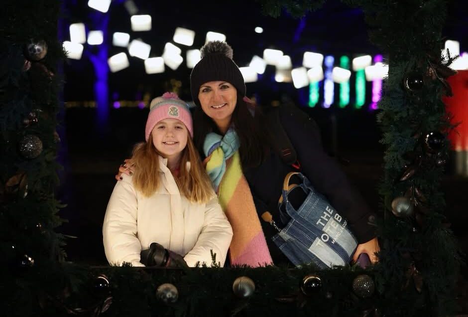 Lynsey and her daughter smiling to camera at Christmas at Bute Park