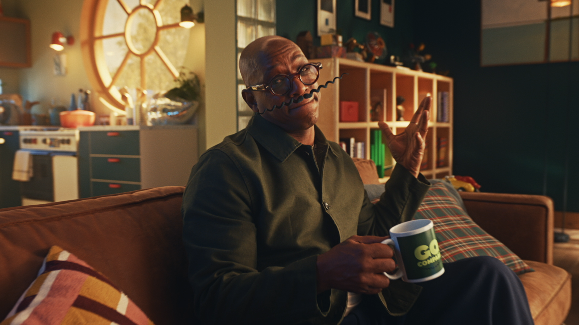 Ian Wright sits on the sofa with a moustache