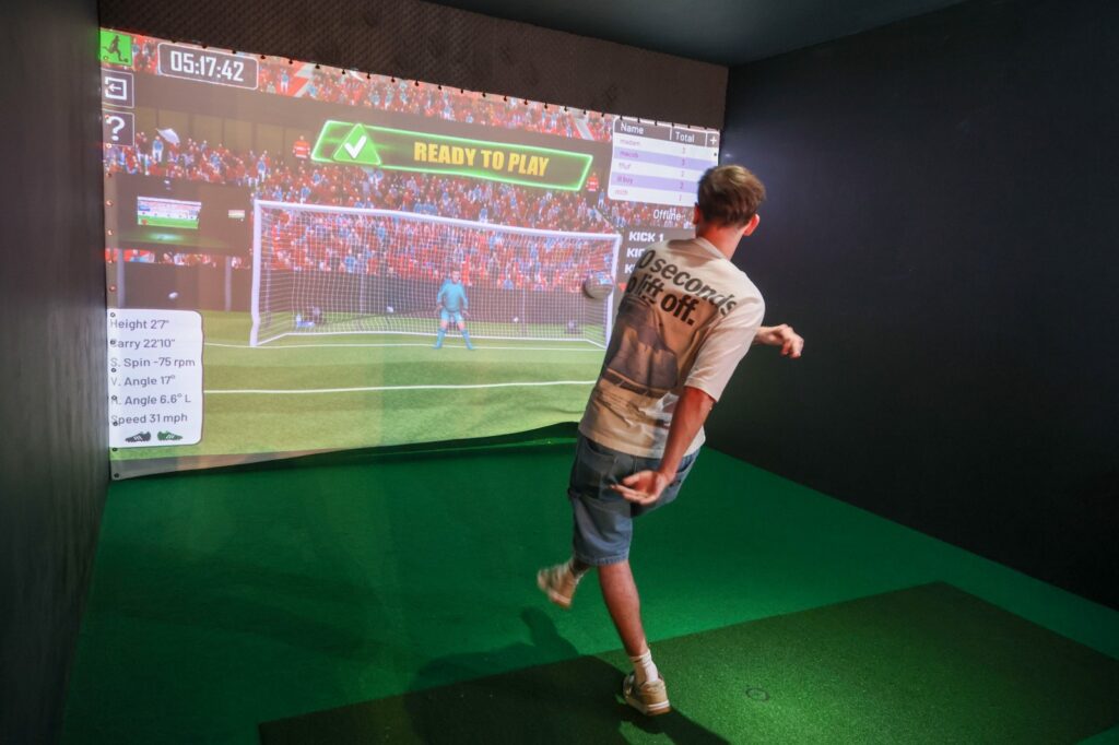 Iwan kicking a football at the pub